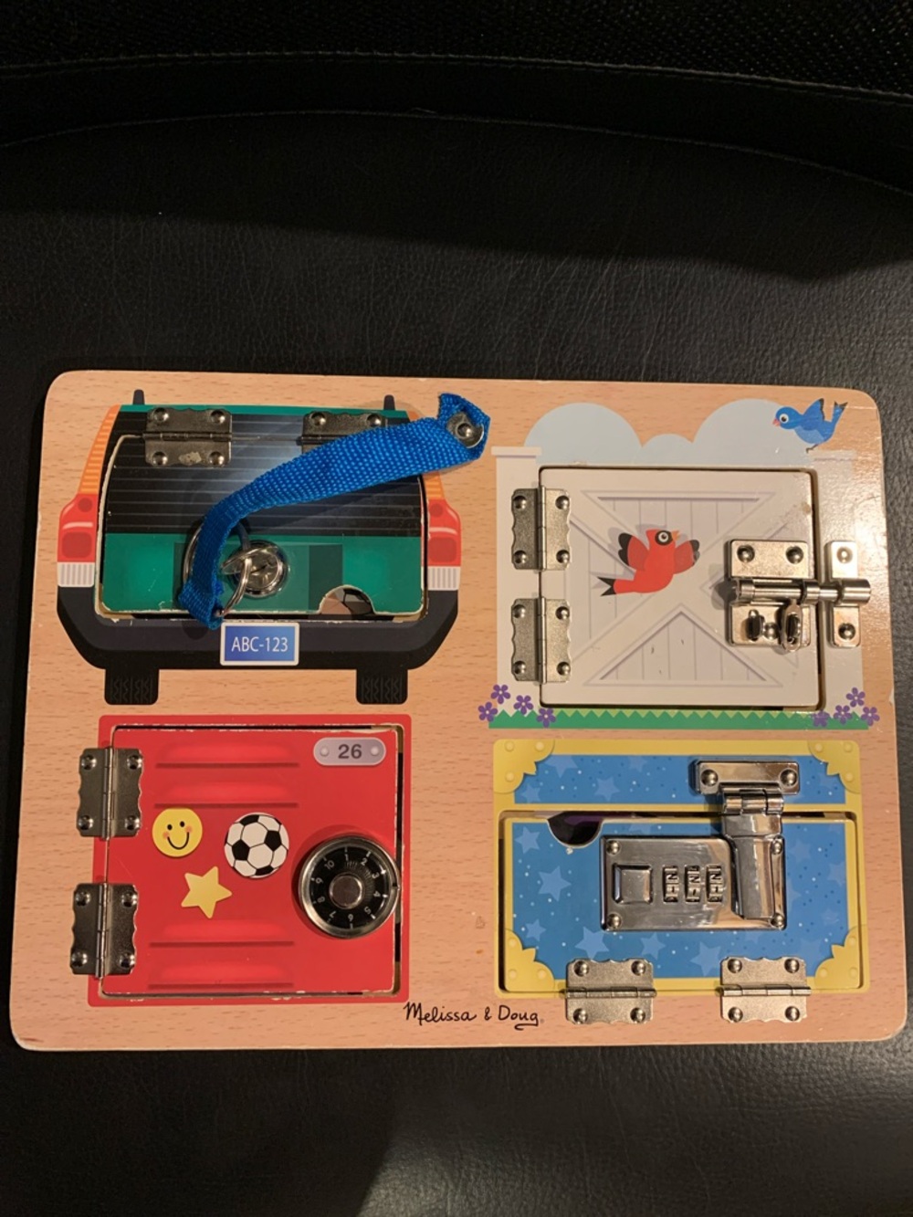 Melissa & Doug Wooden Lockboard Toy - Red, Blue, Green, Yellow, White